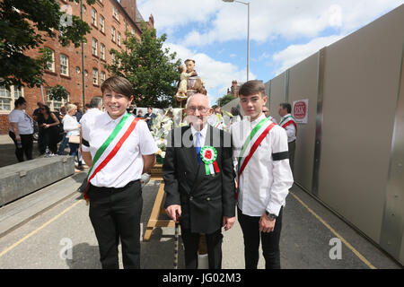 Manchester, UK. 2nd July, 2017. . An older man stood with lads ready for the  Madonna del Rosario procession,  Manchester,2nd July, 2017  Credit: Barbara Cook/Alamy Live News Stock Photo
