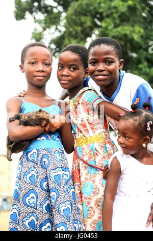 In Ivory Coast keep Raccoons as pets as well as for consumption purposes. This animal coexist with kids who use them as play friends Stock Photo