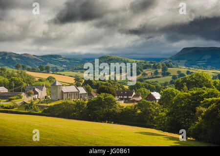 Powys, Wales UK. Tuesday 03 July 2017. UK weather: Sunshine and showers over the ancient church of Llanddewi'r Cwm, nestling in the green rolling hills near Builth Wells, in Powys, mid Wales Credit: keith morris/Alamy Live News Stock Photo