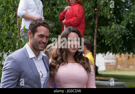 Hampton Court Palace, East Molesey, UK. 3rd July, 2017. Kelly Brook and Jeremy Parisi on The Centre For Mental Health Garden: On The Edge. The world’s biggest annual flower show runs from 4-9 July, flanking both sides of the Long Water at Hampton Court Palace and includes Show Gardens, Rose Marquee, Floral Marquee and plant pavilions. Credit: Malcolm Park / Alamy Live News. Stock Photo