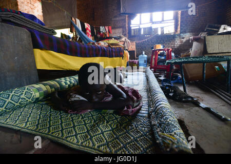 July 3, 2017 - Wau, Wau, South Sudan - A young internal  refugee boy, takes some rest in the St. Mary's Help of Christian Parish Cathedral in Wau, South Sudan on Monday. Thousands of South Sudanese found refuge with in the grounds of the church since June 2016 and haven't have their food rations from the World Food Program since past March. (Credit Image: © Miguel Juarez Lugo via ZUMA Wire) Stock Photo