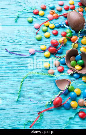 Multicolored dragees, chocolate eggs, ribbons Stock Photo