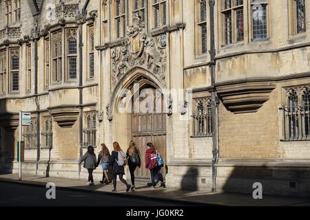Female students walking past Brasenose college Stock Photo