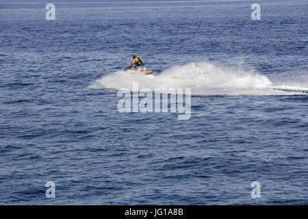 The young Man riding jet ski in blue sea Stock Photo