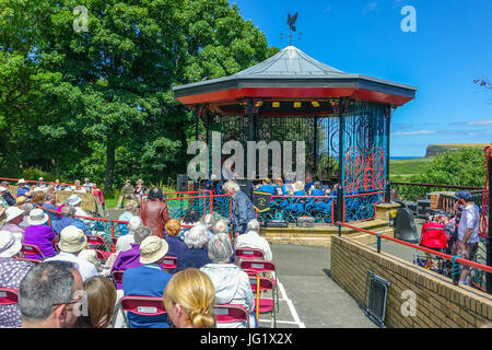 Saltburn-by-the-Sea bandstand with silver band and big audience Stock Photo