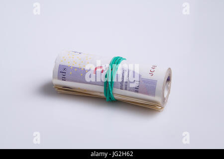 Warsaw, Poland - July 1, 2017: British currency. Roll of twenty pound notes held by rubber band Stock Photo