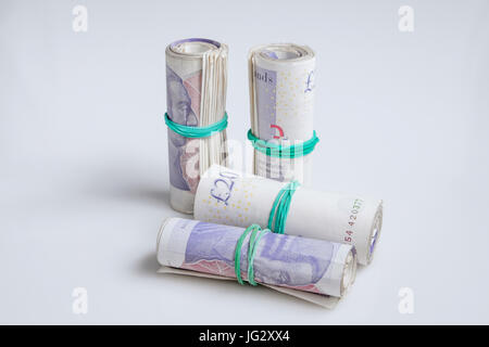 Warsaw, Poland - July 1, 2017: British currency. Four rolls of twenty pound notes held by rubber band Stock Photo