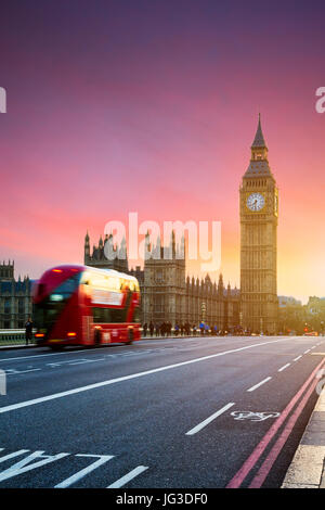 London, the UK. Red bus in motion and Big Ben, the Palace of Westminster. The icons of England Stock Photo
