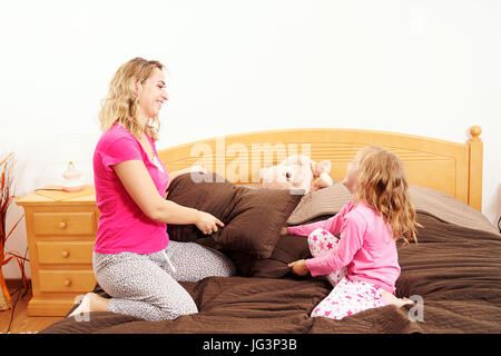 Happy family fighting with pillows indoors Stock Photo