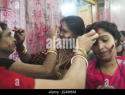 Abhisek Saha / Le Pictorium -  Kharchi Puja festival in India -  22/06/2017  -  India / Tripura / Agartala  -  Women are drawing swastik (Holy Sign) in the temple  and giving vermilion with wish of a happy married life  on the occeasion of Ambubachi , in a temple of Agartala, capital of the northeastern state of Tripura.                                                              Ambubachi is the celebration of the menstruation  of mother earth.The belive is, During Ambubachi , for three days mother earth herself menstruates.Pix By-Abhisek Saha Stock Photo