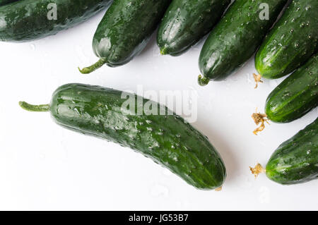 Freshly washed cucumbers on white wooden table Stock Photo