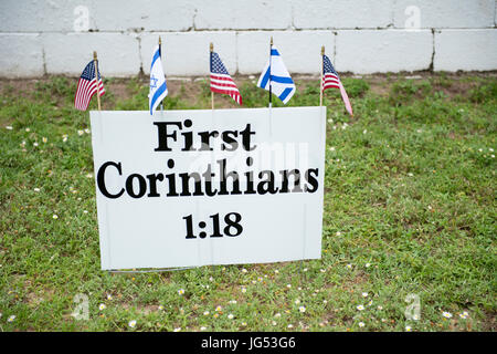 Pensacola, Florida, USA. 27th June, 2017. Bible verse displayed on sign with American and Jewish flag nearby the Save the Bayview Cross Rally.   Sandy Stock Photo