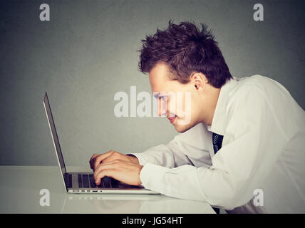 Happy man working on laptop computer Stock Photo