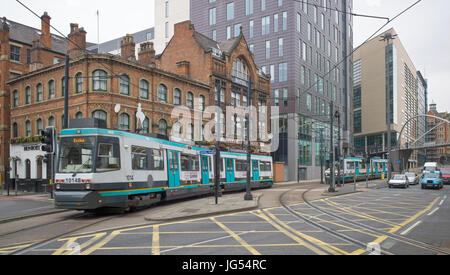 Manchester Metrolink T-68A tram 1014 crossing London Road after leaving Piccadilly station on a service to Eccles. A tram to Piccadilly approaches. UK Stock Photo