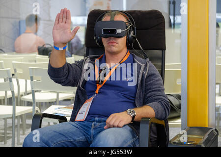 VR conference visitor tests virtual reality helmet Stock Photo