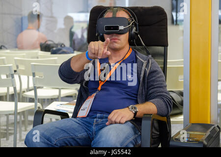 VR conference visitor tests virtual reality helmet Stock Photo