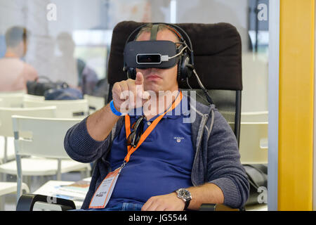 VR conference visitor tests virtual reality helmet Stock Photo