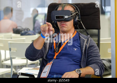 VR conference visitor tests virtual reality helmet Stock Photo