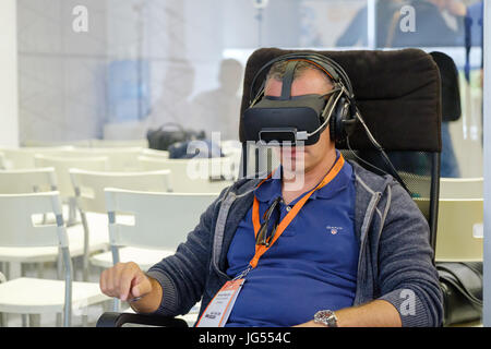 VR conference visitor tests virtual reality helmet Stock Photo