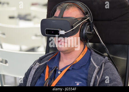 VR conference visitor tests virtual reality helmet Stock Photo