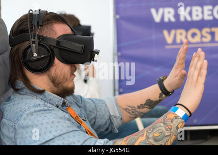 VR conference visitor tests virtual reality helmet Stock Photo