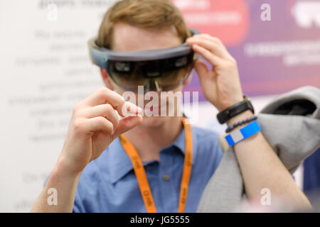 Young man testing hololens VR glasses at VR conference Stock Photo