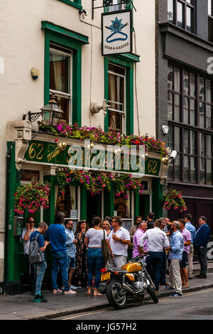 A Large Group Of People Drinking Outside The Star and Garter Pub, Poland Street, London, UK Stock Photo