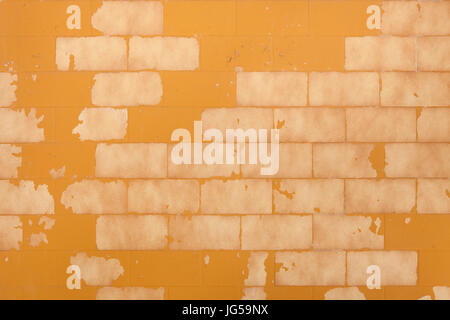 Brick wall painted yellow ochre. Background texture. Stock Photo
