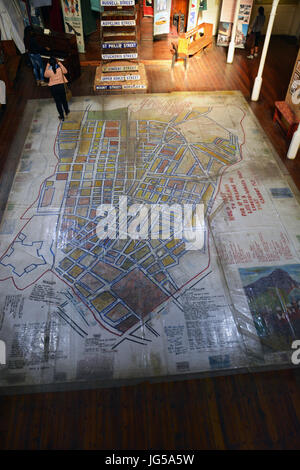 Main floor of the District Six Museum has a neighborhood floor map and other artifacts before residents were forcibly removed by the government. Stock Photo