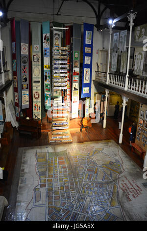 Main floor of the District Six Museum has a neighborhood floor map and other artifacts before residents were forcibly removed by the government. Stock Photo