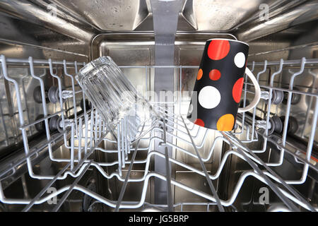Dishwasher with clean cups inside close-up. Inside of dishwaher machine Stock Photo