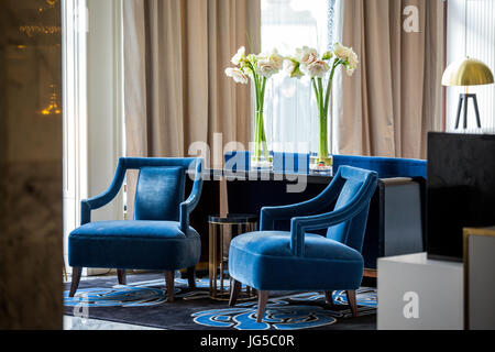 Elegant navy blue armchairs  and flowers on the table Stock Photo