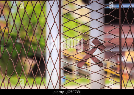 Hammer and axe on the mine fence Stock Photo