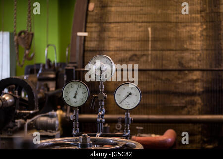 Vintage mining winch empowered by steam engine.Gauges and flywheel. Stock Photo