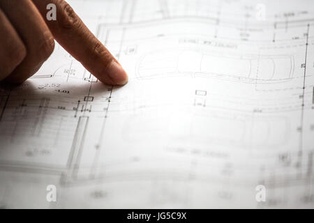 Pointing to specific place on architectural sketches of new house Stock Photo