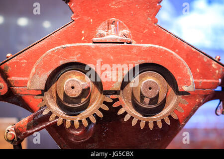 Red, vintage gears used for grinding hop in museum of brewery Stock Photo