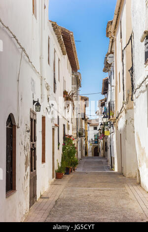 Narrow street with white houses in Requena, Spain Stock Photo