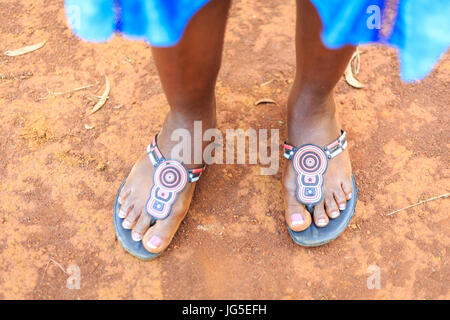 Feet of elegant black woman standing on african ground Stock Photo