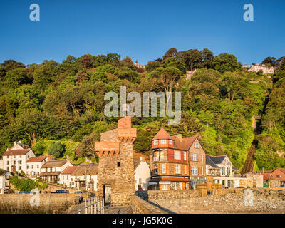 19 June 2017: Lynmouth, Devon, UK - Buildings at the corner of Riverside Road and The Esplanade in Lynmouth, Devon seen from the pier at dawn Stock Photo