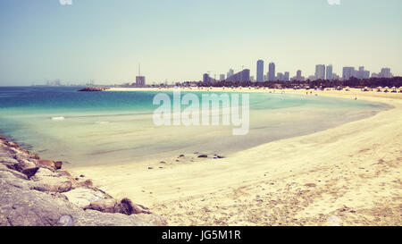 Color toned picture of Al Mamzar Beach Park in Dubai, Sharjah city in distance, United Arab Emirates. Stock Photo