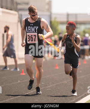 A visually impaired Army veteran trains with a guide at Lane Tech in Chicago on July 2, 2017, preparing to compete in track at the 2017 Department of Defense Warrior Games, an annual Paralympic-style sports event for wounded, ill, and injured service members and veterans. Stock Photo