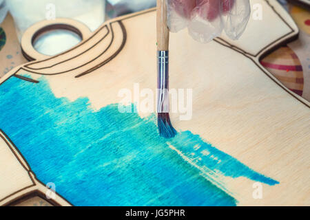 Close up painting wooden board in shape of T-shirt Stock Photo