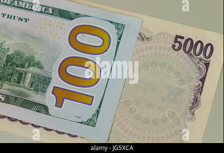 Many kind of banknotes - close up. US 100 dollar bill and Japan 5,000 yen bill. Close up. Stock Photo