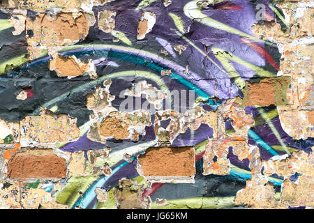 graffiti wall background with peeling paint - vintage brick wall with peeling paint Stock Photo