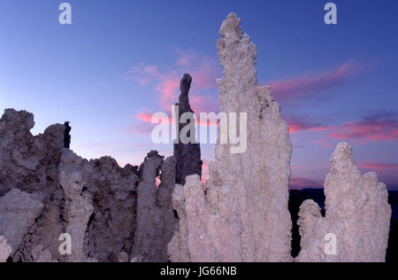Unusual tufa formations look more surreal with added artificial  lighting at sunset at  Mono Lake in California, Stock Photo