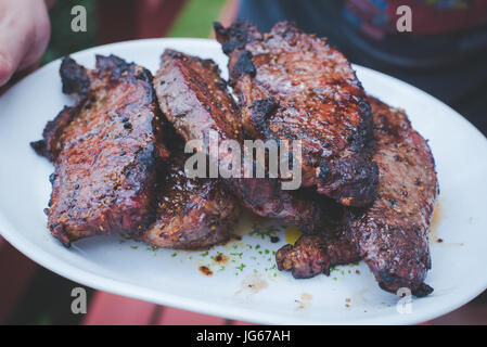 Grilled steak piled on a plate. Stock Photo