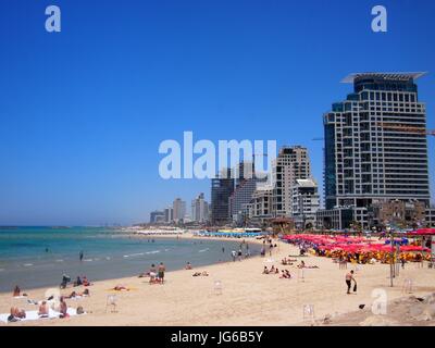 Tel Aviv, Israel - 07 June, 2017: A beautiful clear and sunny day, with locals relaxing on the white sandy beaches and the turquoise Mediterrenean Sea Stock Photo