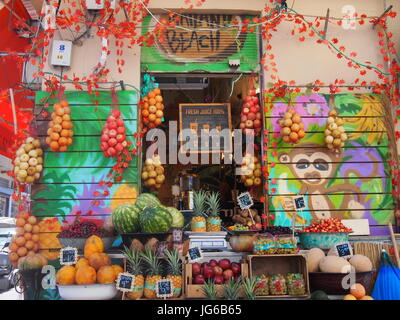 Tel Aviv, Israel - 07 June, 2017: A woman working at her colourful fruit smoothie shop Stock Photo