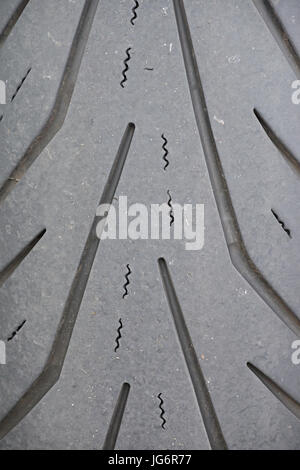 A section of a motorcycle tyre with a close up of the tyre tread Stock Photo