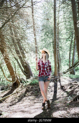 A young blonde female hker relaxing on a trail Stock Photo